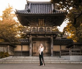Woman standing in front of ancient temple Stock Photo