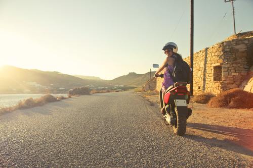 Woman wearing helmet riding a motorcycle Stock Photo