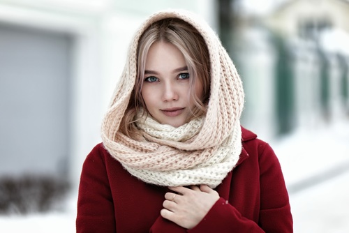 Woman wearing knit scarf outdoor in winter Stock Photo