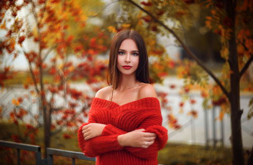 Woman wearing red sweater arms standing outdoors Stock Photo