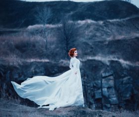 Woman wearing white long dress outdoors Stock Photo