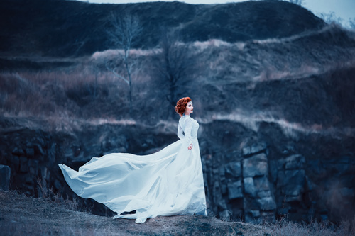 Woman wearing white long dress outdoors Stock Photo
