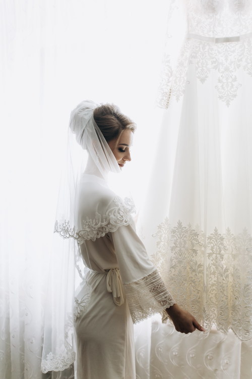 Woman wearing white traditional wedding dress Stock Photo