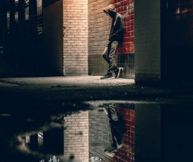Young man standing under the street light Stock Photo