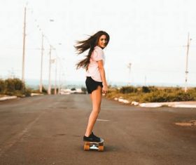 girl riding skateboard at the road Stock Photo