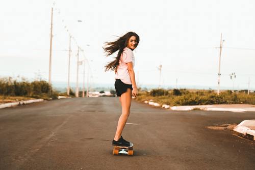girl riding skateboard at the road Stock Photo