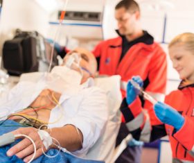 Ambulance personnel and seriously ill patients Stock Photo