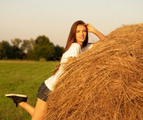Beautiful girl and haystack Stock Photo