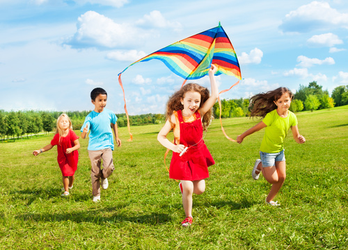 Children flying kites Stock Photo