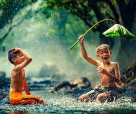 Children playing in the river with lotus leaves Stock Photo 01
