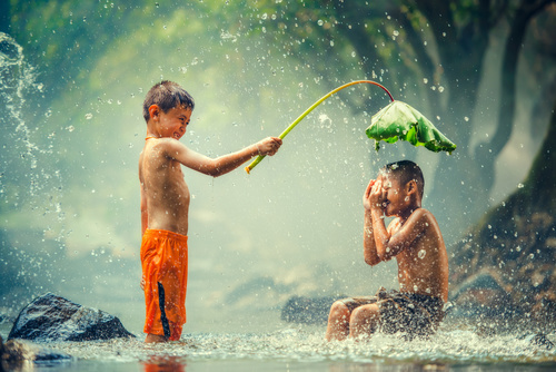 Children playing in the river with lotus leaves Stock Photo 02