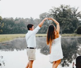 Couple dancing by the lake Stock Photo