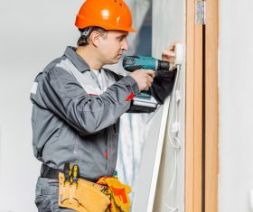Electrician technician installing switch Stock Photo
