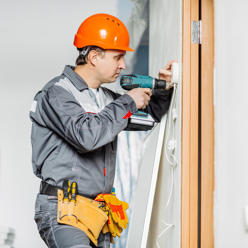 Electrician technician installing switch Stock Photo