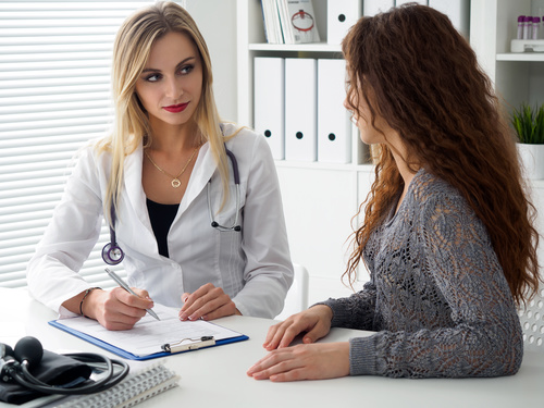 Female doctor asks the patient about the condition Stock Photo