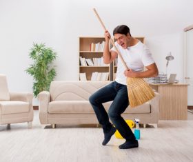 Funny man holding a broom Stock Photo