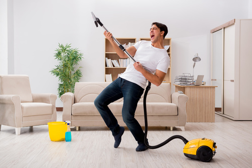 Funny man holding vacuum cleaner Stock Photo 01