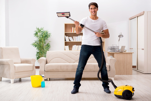 Funny man holding vacuum cleaner Stock Photo 02