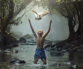 Happy little boy and duck flying up Stock Photo