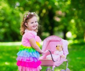 Little girl pushing a buggy Stock Photo
