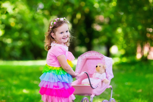 Little girl pushing a buggy Stock Photo