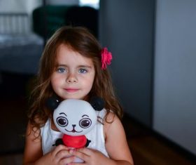 Little girl with panda toy Stock Photo