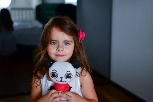 Little girl with panda toy Stock Photo