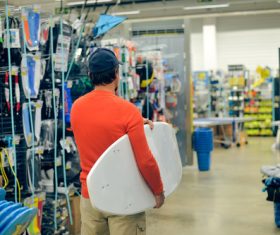 Man buys surfboard at the Sporting goods store Stock Photo