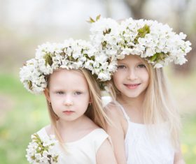 Sisters with white garlands Stock Photo