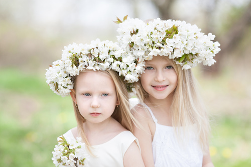 Sisters with white garlands Stock Photo