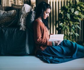 Sitting indoor woman reading book Stock Photo