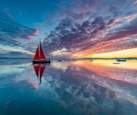 Sky clouds sunlight boat reflection in sea water Stock Photo