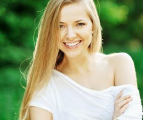 Smiling woman wearing white T-shirt Stock Photo
