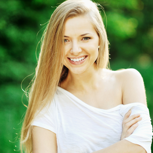 Smiling woman wearing white T-shirt Stock Photo
