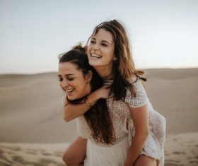 Two happy women in the desert Stock Photo