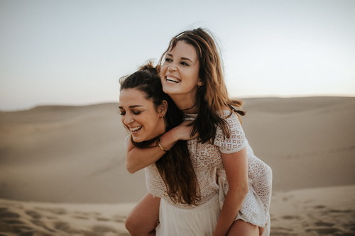 Two happy women in the desert Stock Photo