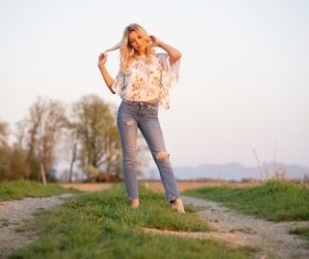Wear torn jeans women standing outdoor Stock Photo