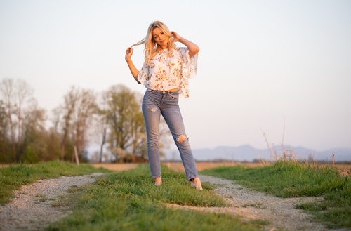 Wear torn jeans women standing outdoor Stock Photo