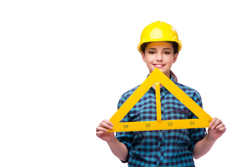 Wearing overalls woman holding a triangle ruler Stock Photo