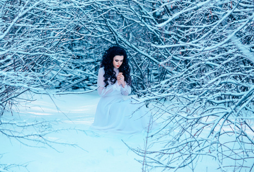 Winter outdoor woman wearing white dress Stock Photo