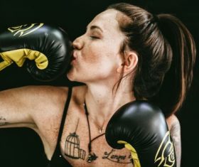 Woman kissing boxing gloves Stock Photo