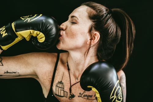 Woman kissing boxing gloves Stock Photo