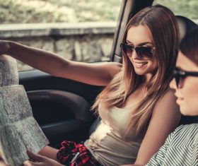 Woman looking at map in car Stock Photo