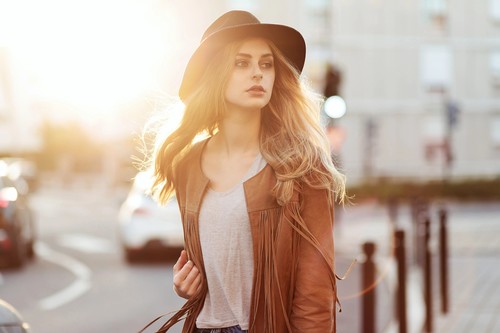 Woman on the street with black hat with blurred sunlight Stock Photo
