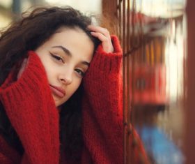 Woman outdoors wearing red sweater coats Stock Photo