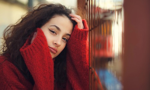 Woman outdoors wearing red sweater coats Stock Photo