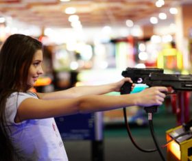 Woman playing shooting game Stock Photo