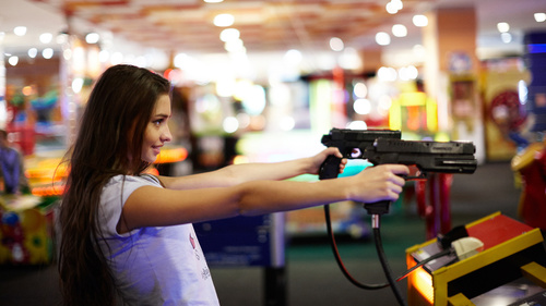 Woman playing shooting game Stock Photo
