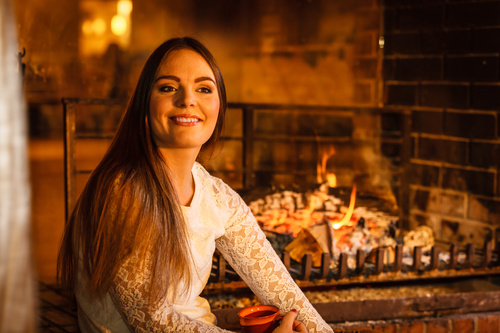 Woman relaxing at fireplace Stock Photo 02