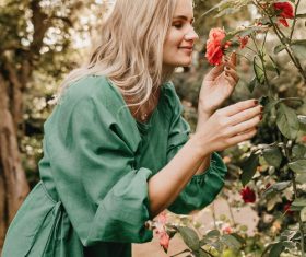 Woman smelling floral side view Stock Photo